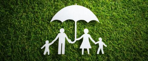 The paper family under an umbrella symbolizing protection and togetherness. photo