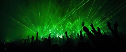 The electric atmosphere of a vibrant crowd at a concert with dazzling lasers. photo