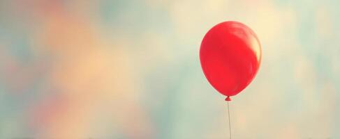 The vibrant red balloon floating against a dreamy pastel sky backdrop. photo
