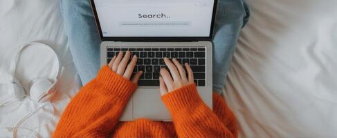 The cozy moment of searching on a laptop from a comfortable bed photo