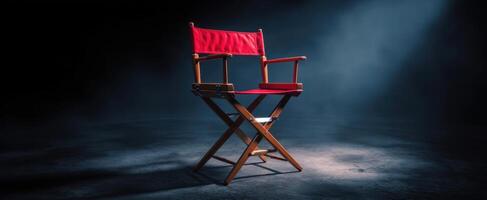 The iconic director's chair illuminated in a dramatic spotlight setting. photo