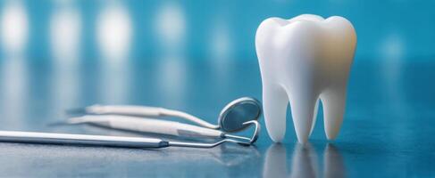 The clean and polished tooth alongside dental instruments on a clinical surface. photo