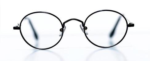 The elegant black round glasses with clear lenses on a clean background. photo