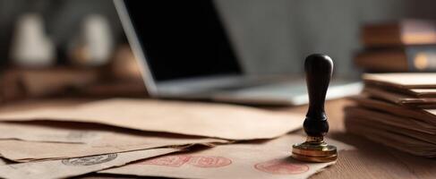 The elegant stamp resting on vintage papers in a modern office setting. photo
