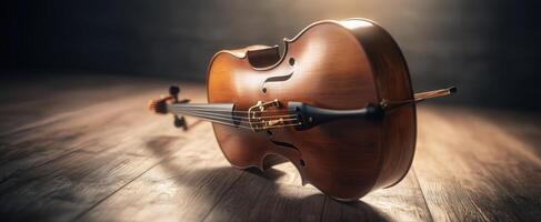The exquisite wooden violin resting gracefully on a wooden floor. photo