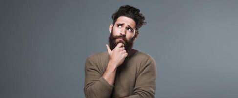 The thoughtful man pondering life's questions with a curious expression. photo