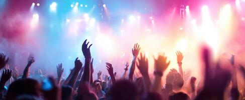 The energetic crowd raising hands at a vibrant music festival. photo