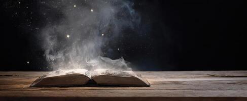 The book releasing magic and sparks into the dark night atmosphere. photo