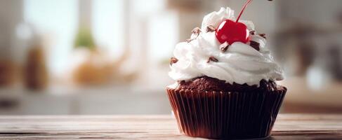 The decadent chocolate cupcake topped with fluffy whipped cream and cherry. photo