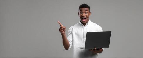 The young man with a laptop excitedly sharing innovative ideas. photo