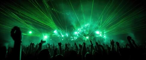 The electrifying concert atmosphere with vibrant green laser lights and enthusiastic crowd. photo