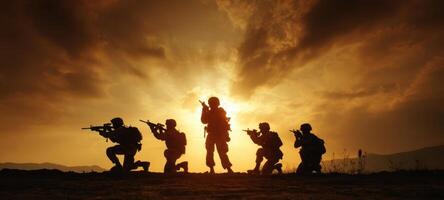 The soldiers in silhouette prepare for action against a dramatic sunset backdrop. photo