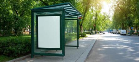 The empty bus stop shelter surrounded by vibrant trees in a sunny urban setting. photo