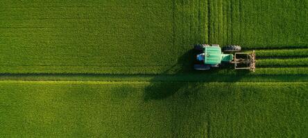 The vibrant green fields being cultivated by a modern agricultural tractor. photo