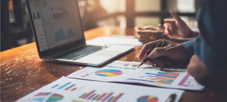 The analysis of business data with graphs and charts in a collaborative workspace. photo