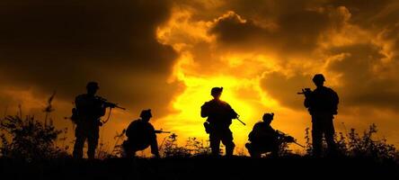 The soldiers striking a heroic pose against a dramatic sunset background. photo