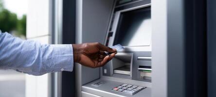 The hand inserting a card into an ATM for cash withdrawal. photo