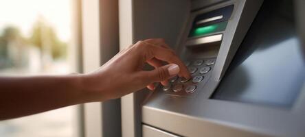 The hand interacting with an ATM in a financial transaction setting. photo