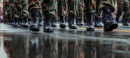 The soldiers in uniform marching proudly on a rain-soaked street. photo