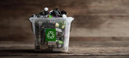 The bucket filled with batteries promoting eco-friendly recycling practices. photo