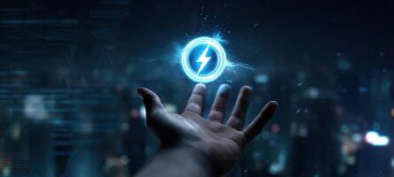 The hand reaching out to grasp a glowing electric energy symbol in a futuristic setting. photo