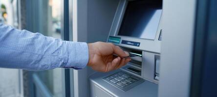 The hand inserting a card into an ATM for a financial transaction. photo