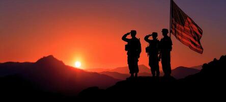 The saluting soldiers honoring the American flag against a vibrant sunset backdrop. photo