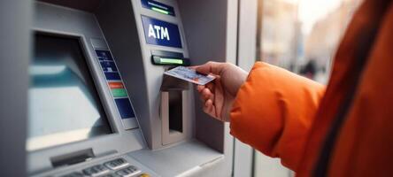 The user interacting with an ATM for a secure banking transaction. photo