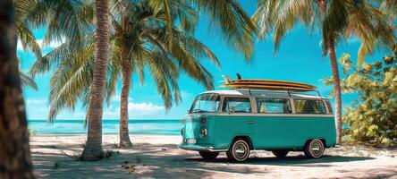 The vibrant turquoise van parked under palm trees at a beautiful beach. photo