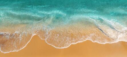 The serene ocean waves gently caress the golden sandy beach at sunset. photo