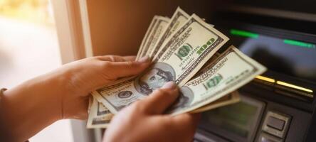The hands holding cash after withdrawing from an ATM machine. photo