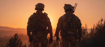 The soldiers standing together at sunset, ready for their next mission. photo