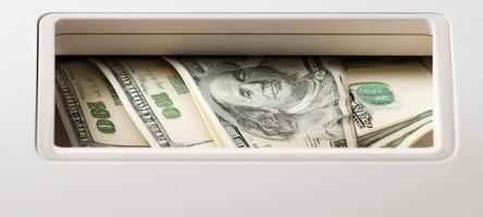 The stack of money nestled in a secure cash compartment. photo