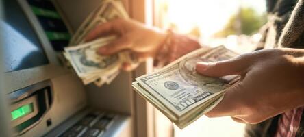 The person retrieving cash from an ATM during a sunny day. photo