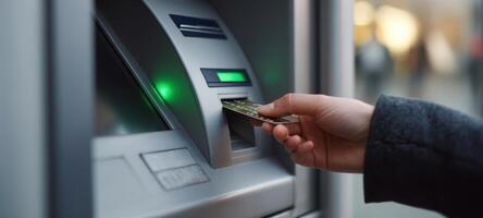 The ATM dispensing cash as a user makes a transaction at night. photo