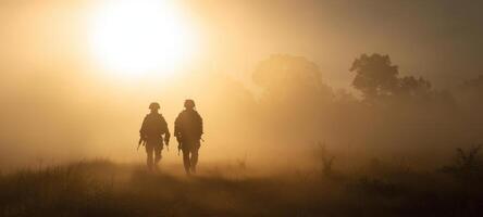 The soldiers walking together in the misty sunrise landscape of camaraderie. photo