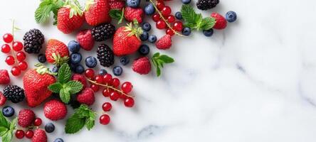 The vibrant assortment of fresh berries on a marble background. photo