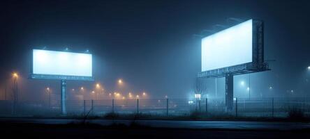 The illuminated billboards beckoning in the foggy night urban landscape. photo