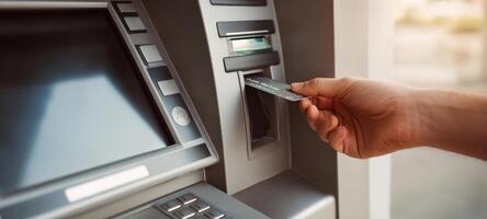The user inserting a card into an ATM for a financial transaction. photo