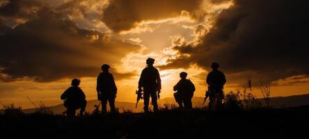 The silhouette of soldiers standing united against a breathtaking sunset backdrop. photo