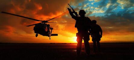 The soldiers prepare for a helicopter mission during a dramatic sunset. photo