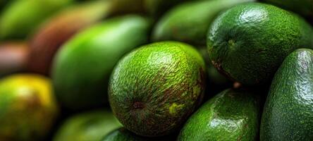 The vibrant green avocados stacked in a fresh produce display. photo