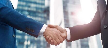 The handshake symbolizing partnership between two business professionals in an urban setting. photo