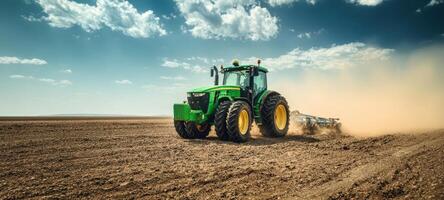 The powerful tractor working diligently in the sunlit agricultural field. photo