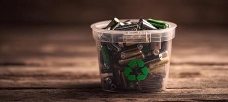 The bucket filled with assorted batteries ready for recycling and proper disposal. photo