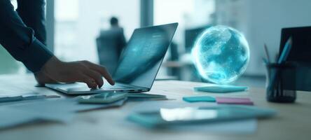 The laptop displaying a holographic globe in a modern creative workspace. photo