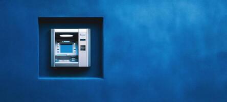 The modern ATM integrated into a stylish blue wall design. photo