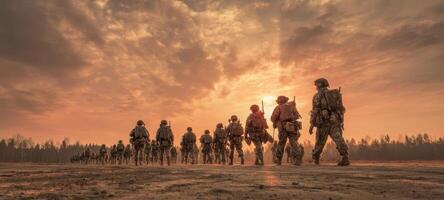 The soldiers marching towards the horizon under a dramatic sunset backdrop. photo