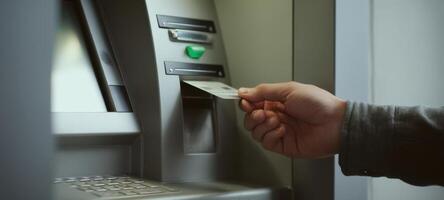 The automated teller machine assisting in a cash withdrawal transaction photo