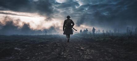 The soldier walking through a foggy battlefield at dusk amidst intense drama. photo